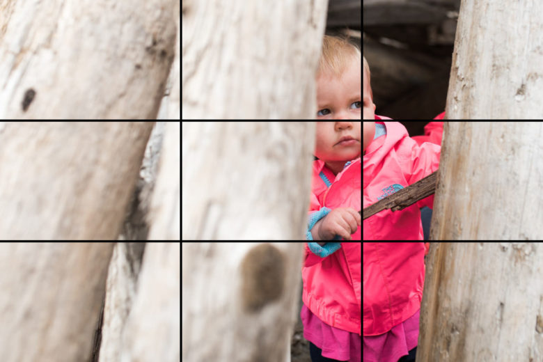 off-centre composition of child on beach